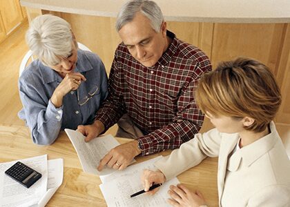 financial advisor reviews documents with couple