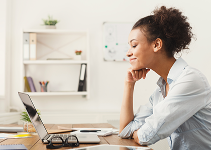 Woman smiling at her laptop