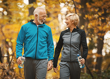 Mature couple out on a walk in the fall leaves