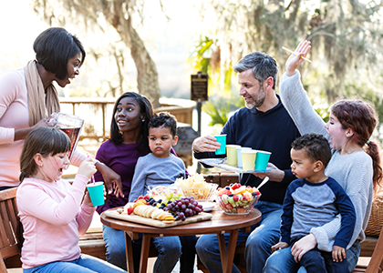 Blended family eating outdoors