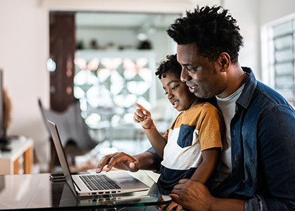 Father and son on computer at home