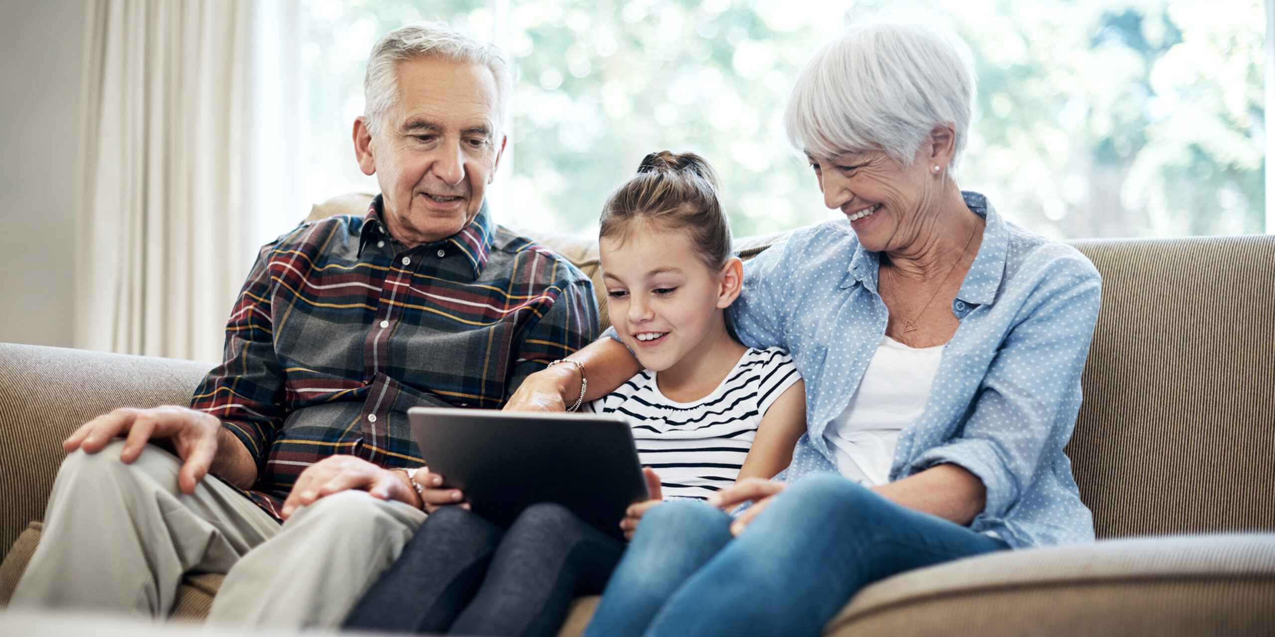 Grandparents reading to grandchild