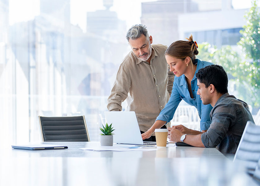 Three business owners reviewing their life insurance options.